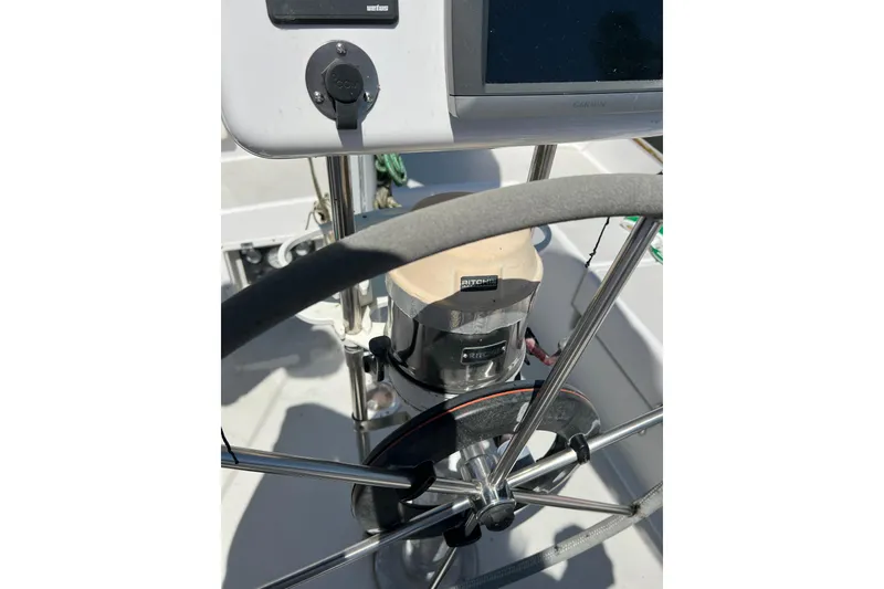 Slide: The Image of Steering wheel and compass on a 1979 Pearson 424 sailboat cockpit. - 19