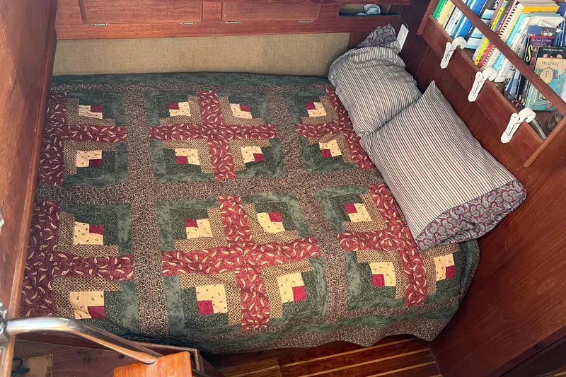 Slide: The Image of Cozy cabin bed with quilt and pillows in 1979 Pearson 424 sailboat. - 33