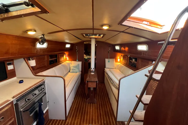 Slide: The Image of Interior of a 1979 Pearson 424 sailboat with wood paneling and cozy seating. - 44