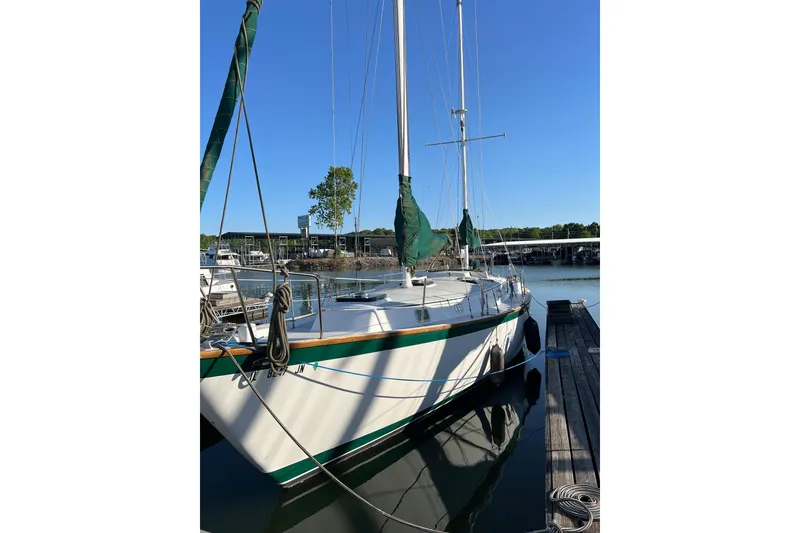 Slide: The Image of 1979 Pearson 424 sailboat docked at marina under clear blue sky. - 5