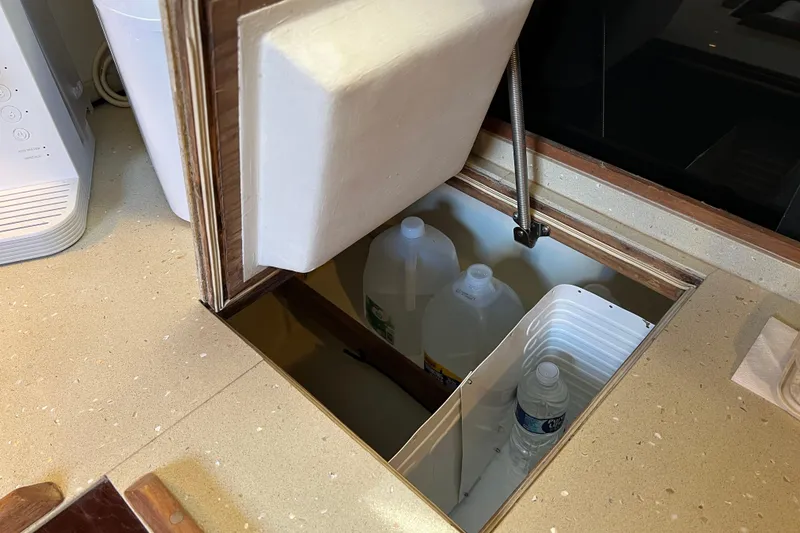 Slide: The Image of Built-in storage compartment on a 1979 Pearson 424 boat, containing water bottles. - 50