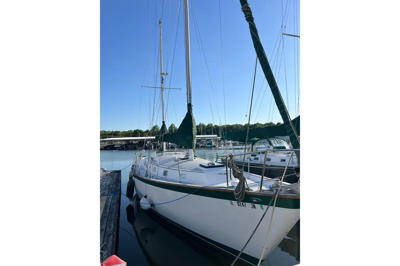 Slide: The Image of 1979 Pearson 424 sailboat docked at marina under clear blue sky. - 6