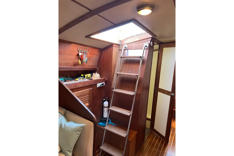 Slide: The Image of Interior of 1979 Pearson 424 sailboat with wooden ladder and tools. - 60