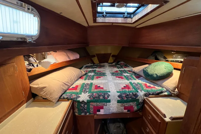 Slide: The Image of Cozy cabin interior of 1979 Pearson 424 sailboat with colorful quilted bedding. - 62