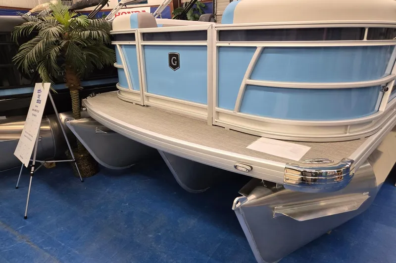 Slide: The Image of 2026 Godfrey Sweetwater 2086 C pontoon boat displayed indoors with blue accents. - 1