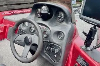 Slide: The Image of 2002 Nitro NX 882 SC boat dashboard with steering wheel and gauges. - 11