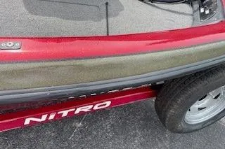 Slide: The Image of 2002 Nitro NX 882 SC boat trailer with red detailing and visible tire. - 18