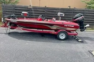 Slide: The Image of 2002 Nitro NX 882 SC fishing boat on trailer, red and black design. - 2