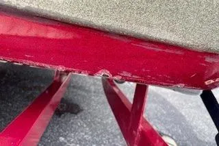 Slide: The Image of 2002 Nitro NX 882 SC boat hull with visible wear and red trailer. - 22