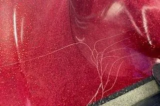 Slide: The Image of Close-up of red Nitro NX 882 SC 2002 boat with visible surface scratches. - 25