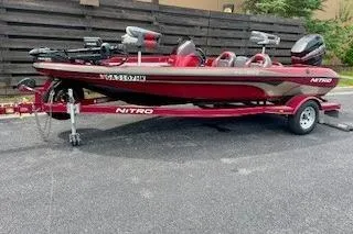 Slide: The Image of Red 2002 Nitro NX 882 SC boat on trailer, parked outdoors. - 4