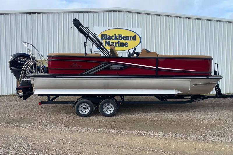 The Image of 2026 SunCatcher Fusion 324RC pontoon boat on trailer at BlackBeard Marine dealership. - 1