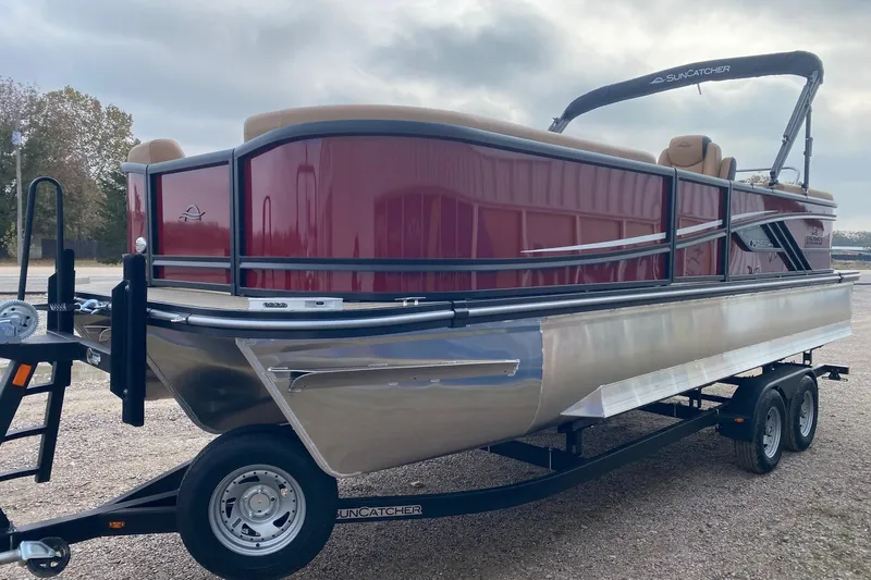 Slide: The Image of 2026 SunCatcher Fusion 324RC pontoon boat on trailer, featuring sleek design and maroon exterior. - 3