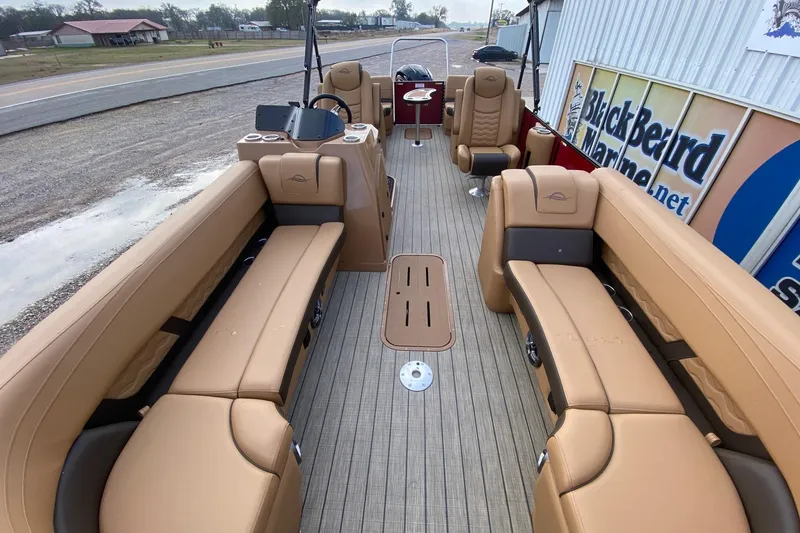 Slide: The Image of 2026 SunCatcher Fusion 324RC pontoon boat with tan seating and modern dashboard. - 6