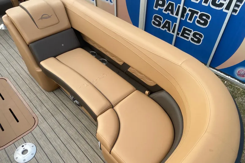 Slide: The Image of Luxurious seating on 2026 SunCatcher Fusion 324RC boat, featuring tan upholstery and cup holders. - 7