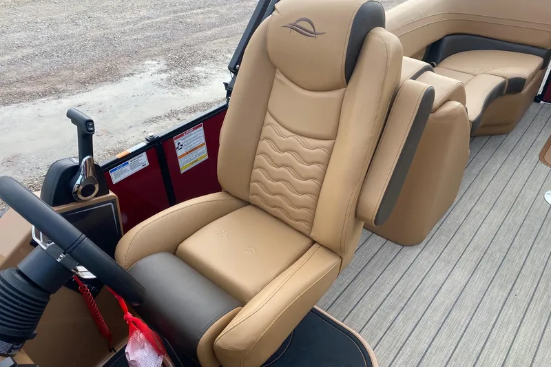 Slide: The Image of Luxurious interior of 2026 SunCatcher Fusion 324RC boat with tan leather seating. - 9