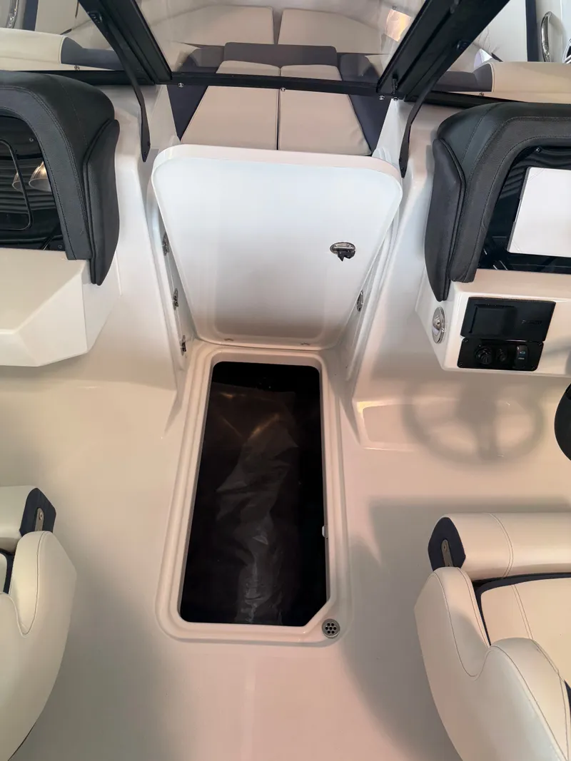 Slide: The Image of Interior of 2026 Stingray 20SBX with storage compartment and seating. - 11
