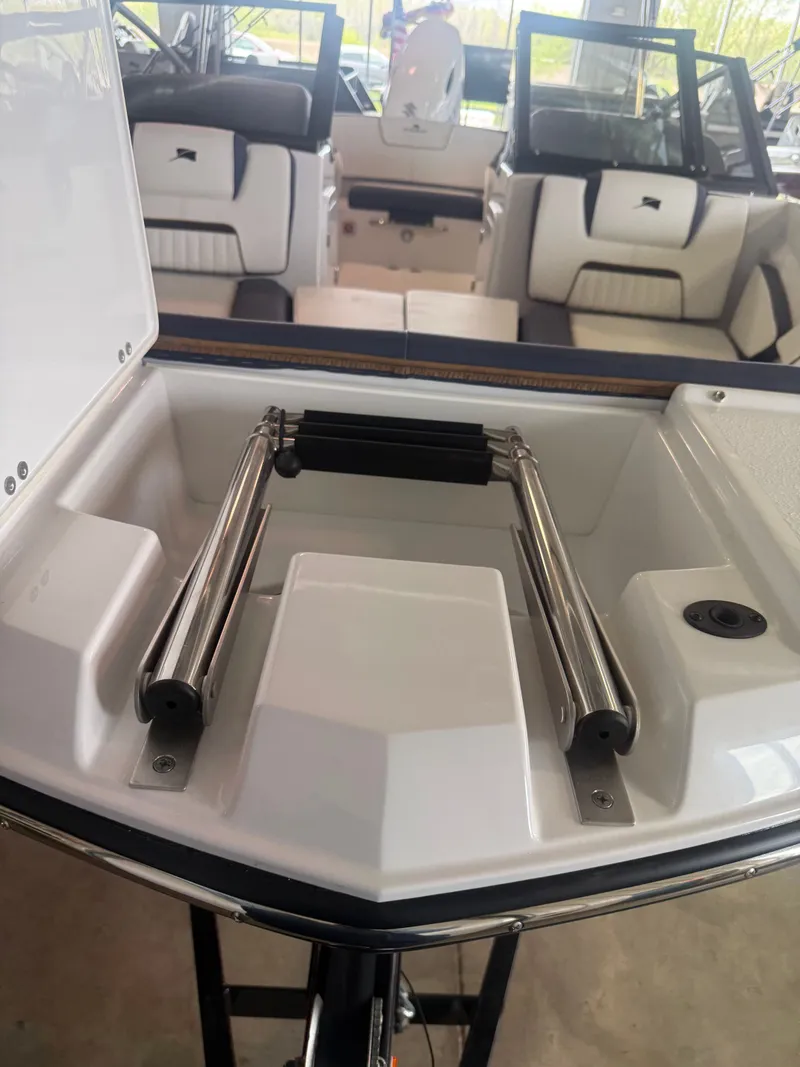 Slide: The Image of 2026 Stingray 20SBX boat with integrated swim ladder. - 14