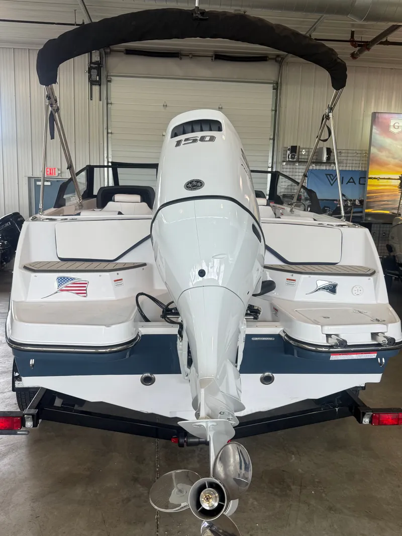 Slide: The Image of Rear view of a 2026 Stingray 20SBX boat with outboard motor. - 2