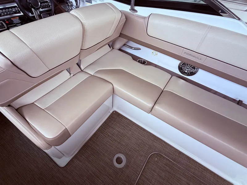 Slide: The Image of Interior of a 2016 Formula 310 BR boat with beige leather seating. - 16
