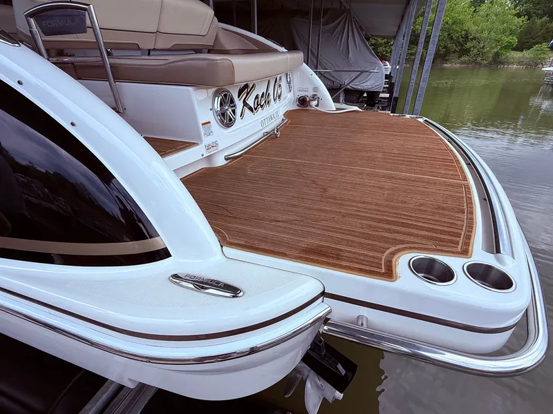 Slide: The Image of 2016 Formula 310 BR boat with wooden deck by the water. - 4