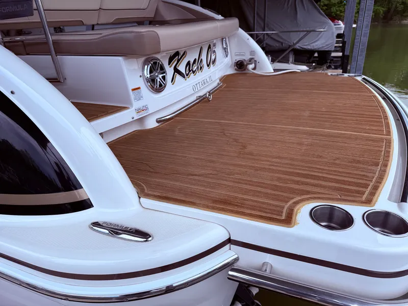 Slide: The Image of Rear view of a 2016 Formula 310 BR boat with wooden deck. - 6