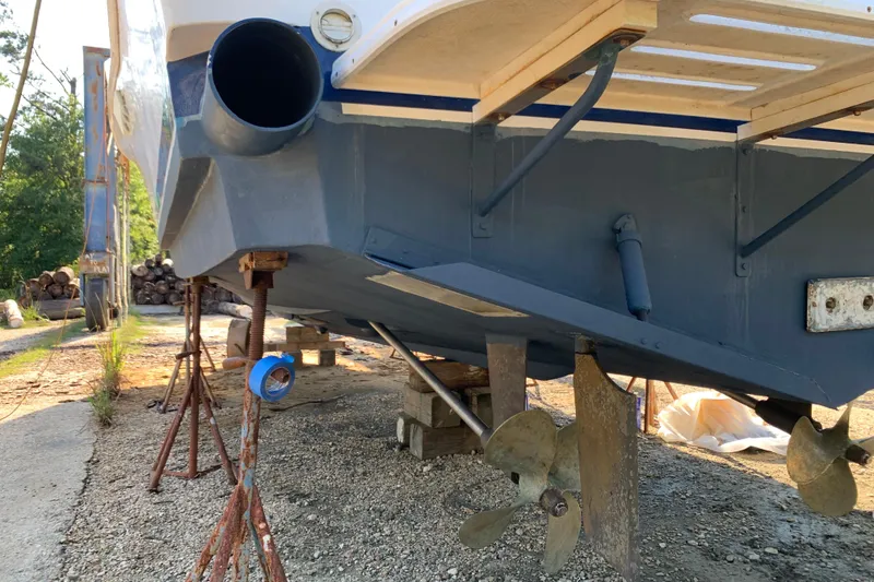 Slide: The Image of 1996 Luhrs 38 Open boat on stands, showing propellers and hull details. - 5