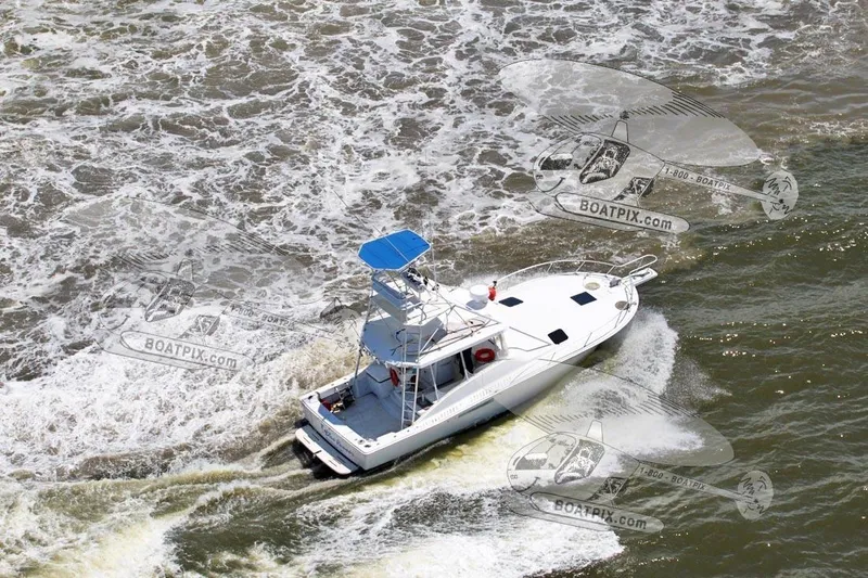 Slide: The Image of Aerial view of a 1996 Luhrs 38 Open boat navigating through choppy waters. - 7