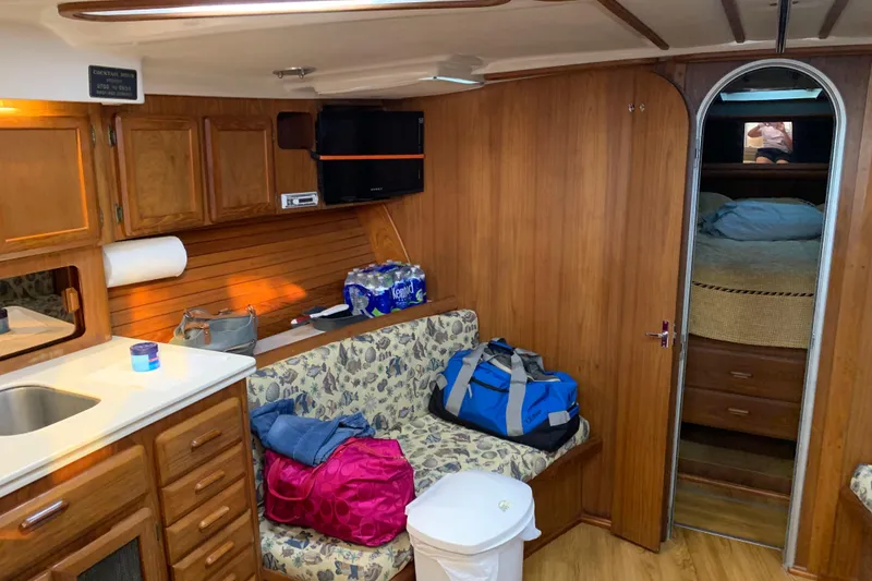 Slide: The Image of Interior of a 1996 Luhrs 38 Open boat with wood finish and cozy seating area. - 8