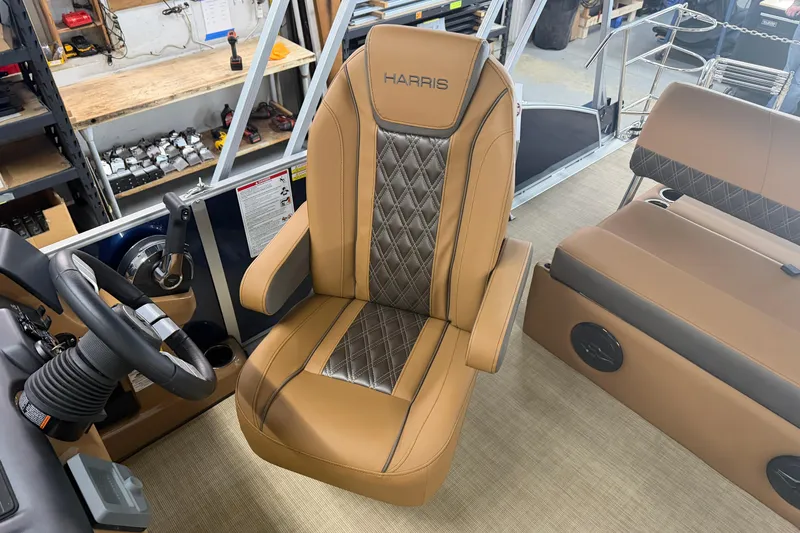 Slide: The Image of Captain's chair on 2026 Harris Cruiser 190 SL pontoon boat, featuring luxurious tan upholstery. - 6