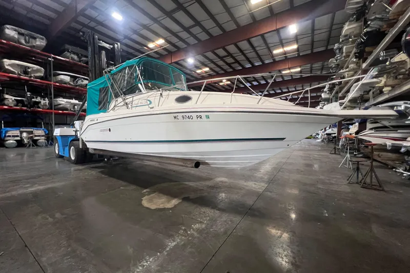 The Image of 1995 Rinker Fiesta Vee 265 boat in indoor storage facility. - 0