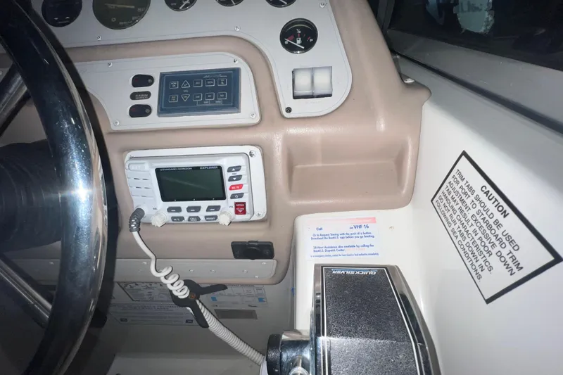 Slide: The Image of 1995 Rinker Fiesta Vee 265 dashboard with steering wheel and control panel. - 11