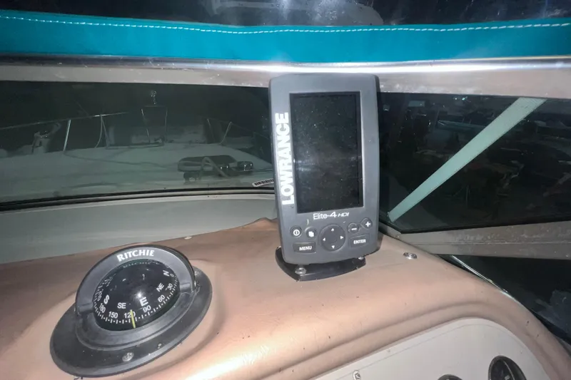 Slide: The Image of Dashboard of 1995 Rinker Fiesta Vee 265 with compass and Lowrance Elite-4 HDI device. - 12