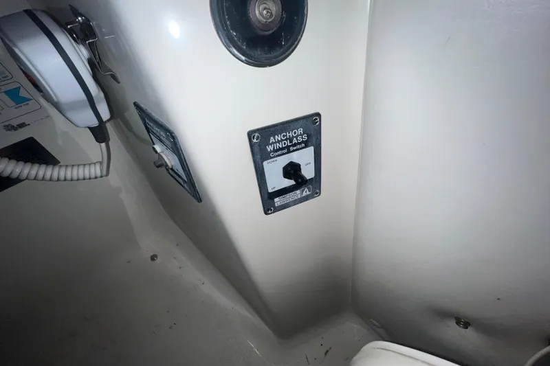 Slide: The Image of 1995 Rinker Fiesta Vee 265 anchor windlass control switch on boat interior panel. - 13