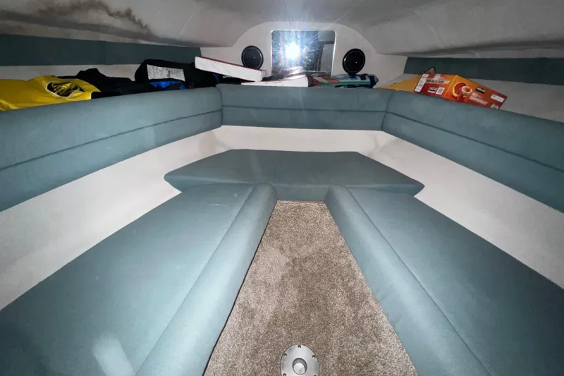 Slide: The Image of Interior cabin of 1995 Rinker Fiesta Vee 265 boat with blue seating and carpeted floor. - 17