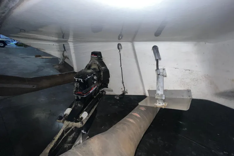 Slide: The Image of 1995 Rinker Fiesta Vee 265 boat underside with visible propeller and rudder components. - 22