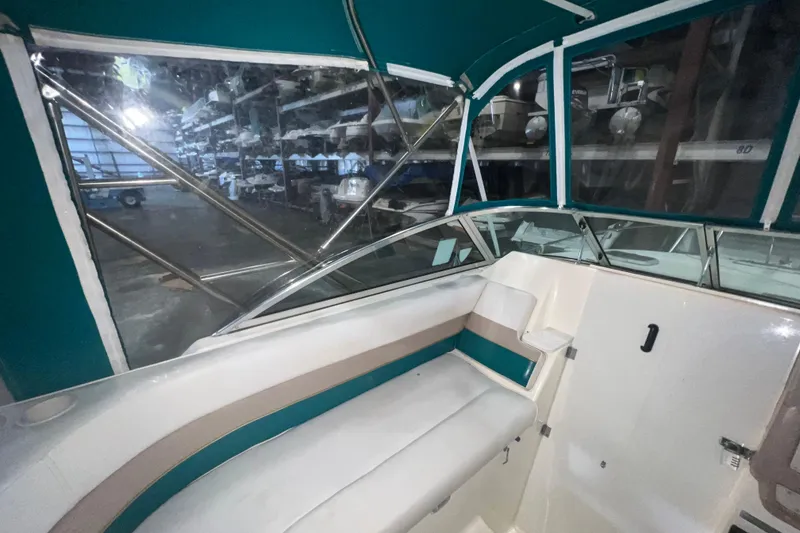 Slide: The Image of Interior of a 1995 Rinker Fiesta Vee 265 boat with teal accents. - 7