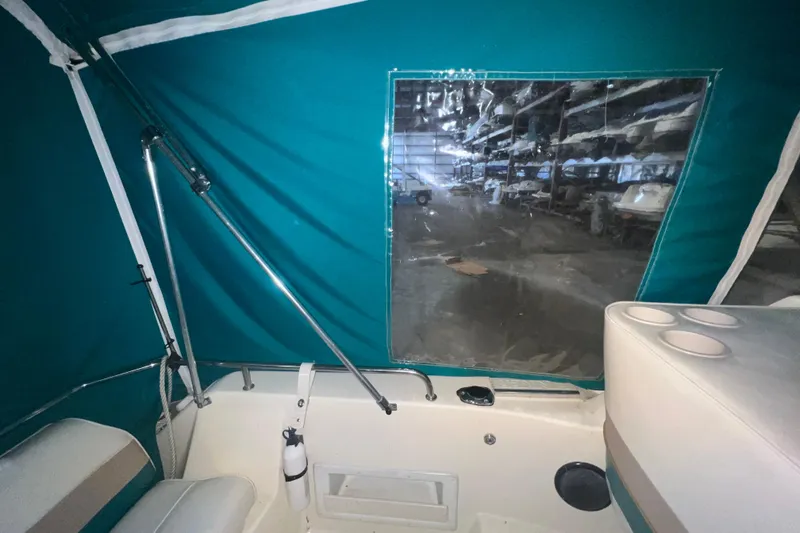 Slide: The Image of Interior view of a 1995 Rinker Fiesta Vee 265 boat with teal canopy. - 9