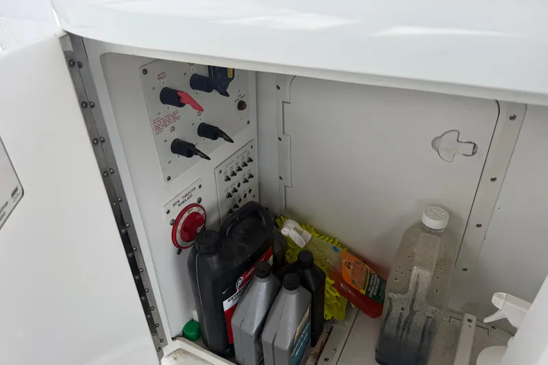 Slide: The Image of Storage compartment of a 2007 Formula 400 Super Sport boat with various maintenance supplies. - 21
