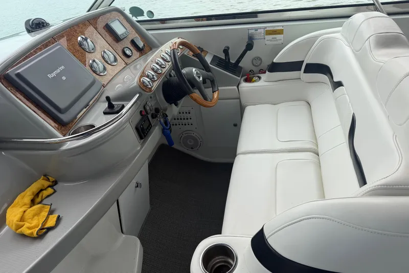 Slide: The Image of 2007 Formula 400 Super Sport boat cockpit with white seating and Raymarine navigation system. - 26