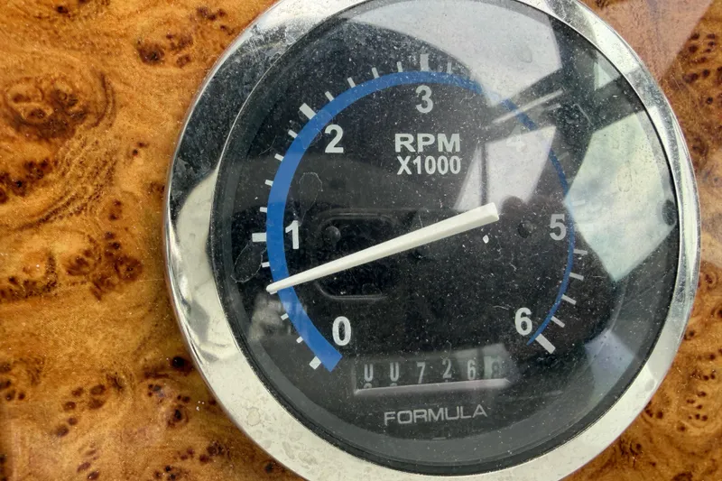 Slide: The Image of Close-up of a 2007 Formula 400 Super Sport RPM gauge on a wooden dashboard. - 27