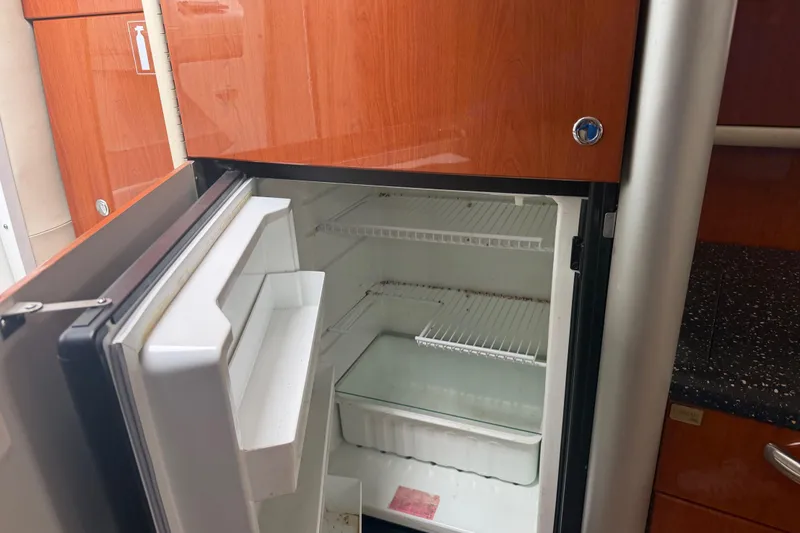 Slide: The Image of Open mini fridge in 2007 Formula 400 Super Sport yacht interior, featuring wooden cabinetry. - 36