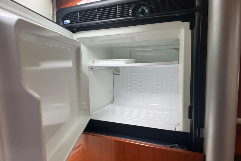 Slide: The Image of Open refrigerator inside a 2007 Formula 400 Super Sport boat, showcasing interior space. - 37