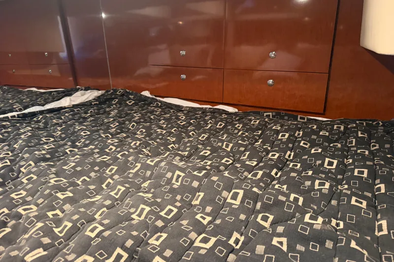 Slide: The Image of Interior of 2007 Formula 400 Super Sport with patterned bedding and wooden cabinetry. - 40