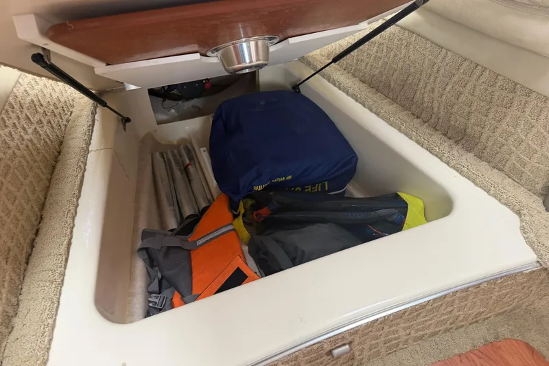 Slide: The Image of Storage compartment in a 2007 Formula 400 Super Sport boat with life jackets and gear. - 42