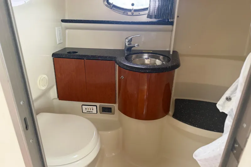 Slide: The Image of 2007 Formula 400 Super Sport yacht bathroom with sink, toilet, and wooden cabinetry. - 44