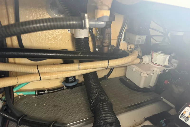 Slide: The Image of Engine compartment of a 2007 Formula 400 Super Sport boat, showcasing hoses and wiring. - 49