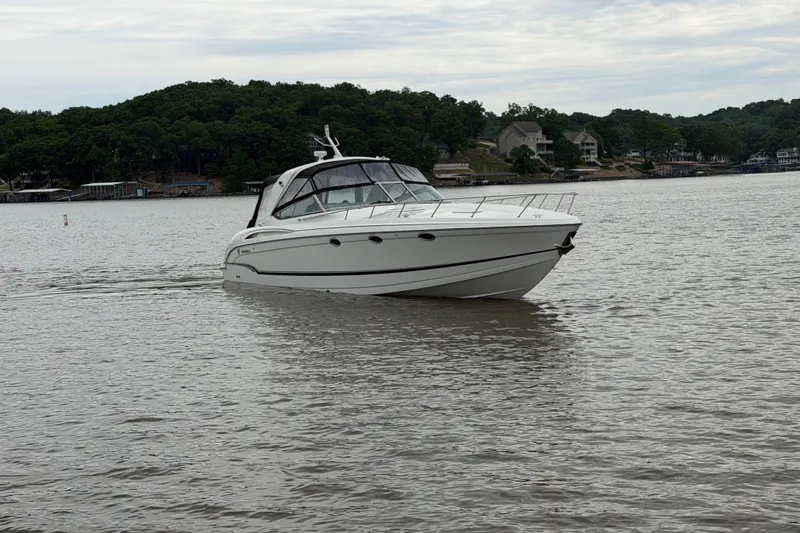 Slide: The Image of 2007 Formula 400 Super Sport boat cruising on a calm lake with wooded shoreline. - 6