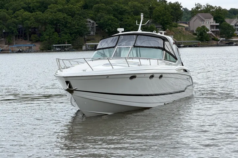 Slide: The Image of 2007 Formula 400 Super Sport boat cruising on a serene lake with lush green shoreline. - 8