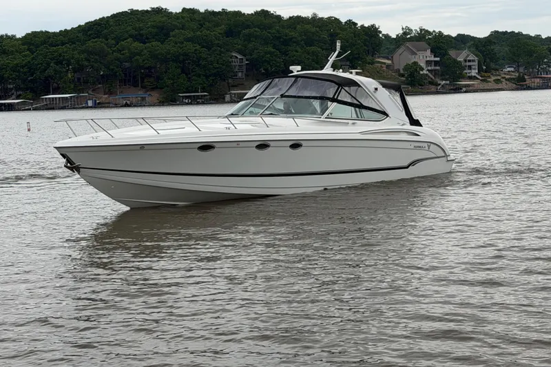 Slide: The Image of 2007 Formula 400 Super Sport boat cruising on a lake with wooded shoreline. - 9